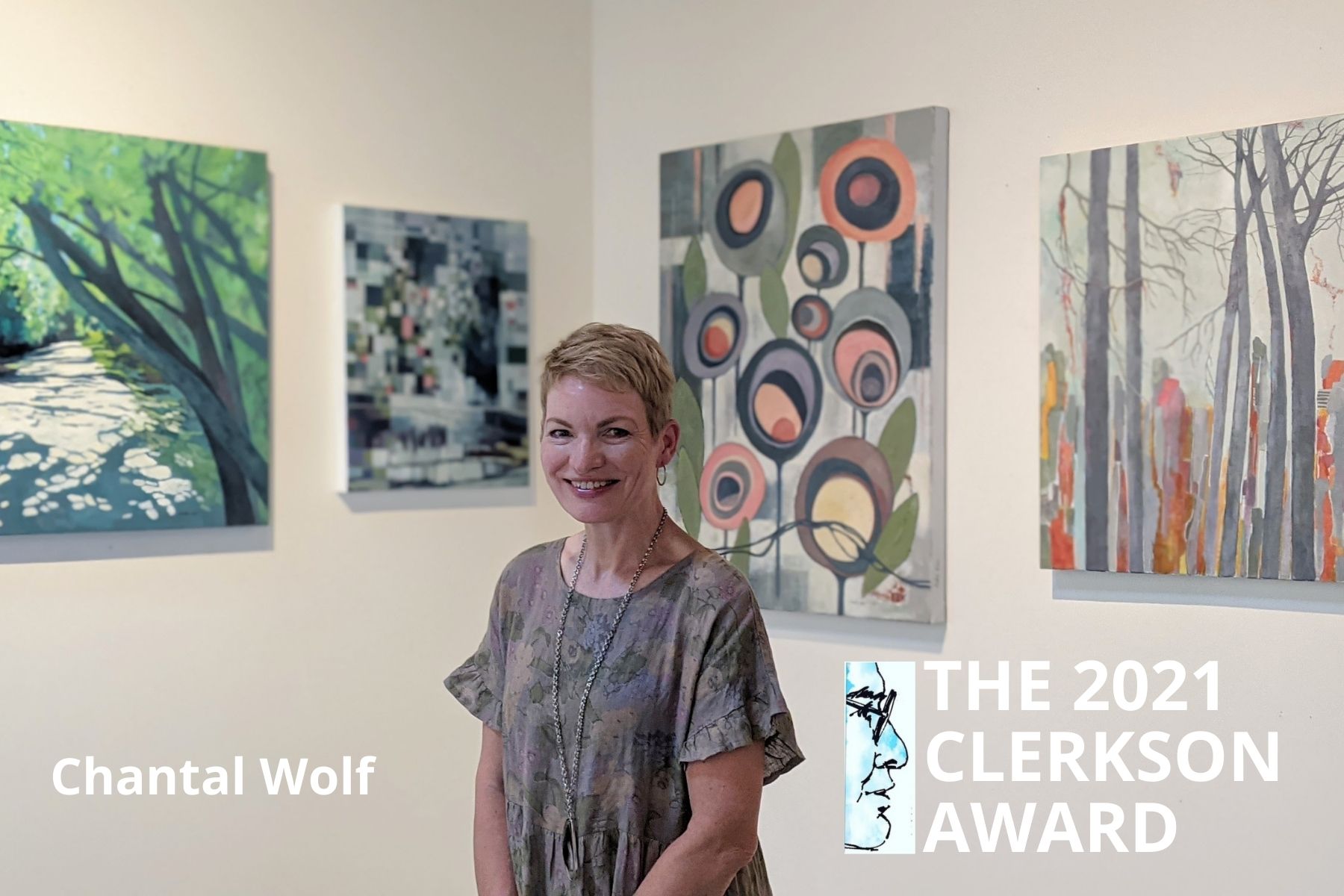Chantal Wolf stands in front of her paintings.